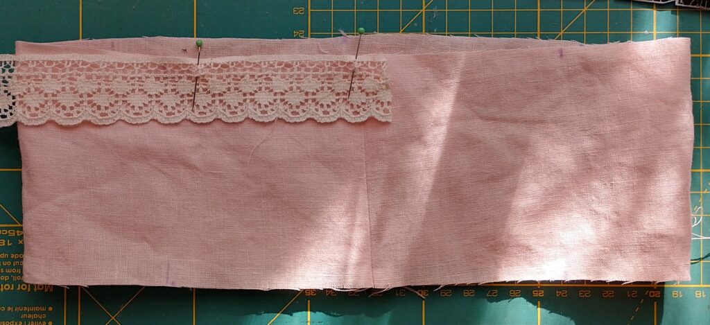 Lace trim on peach linen fabric