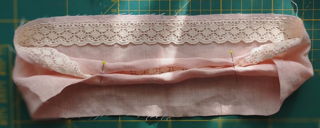 Sewing a scrunchie step: sewing lace trim on peach linen fabric