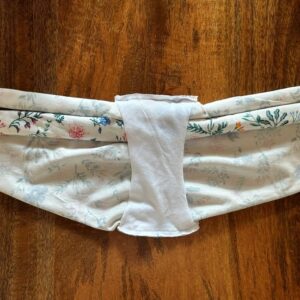 Panties pattern being sewed together using the burrito method for enclosed seams. The font and back pieces are rolled together at the center