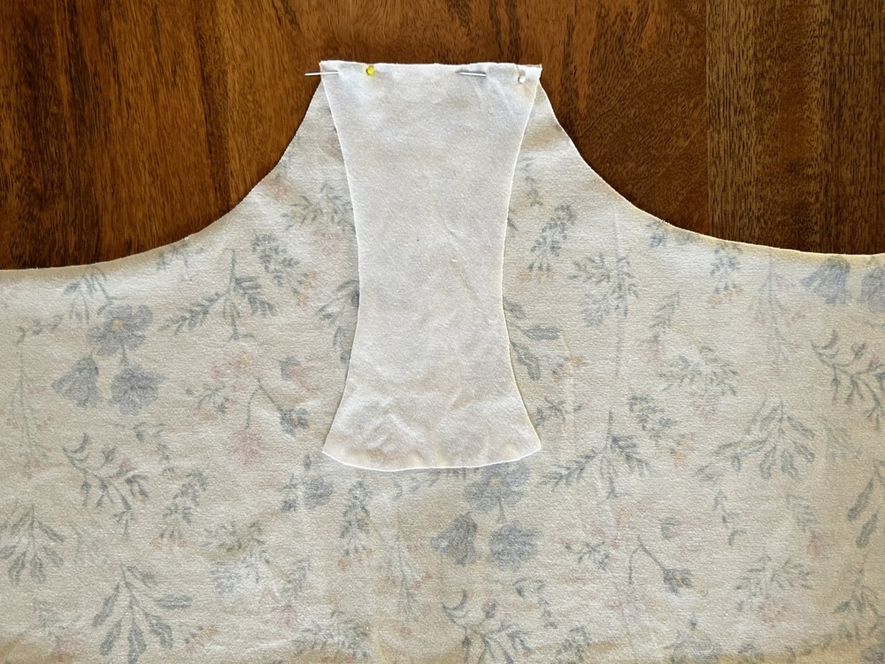 Gusset lining piece pinned on top of the wrong side of the front fabric piece, aligned with the outer gusset.