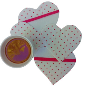 Four heart-shaped coasters and a mug of tea, all from a top view
