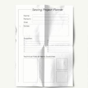 Free Printable Sewing Planner 2 A single printed page of the 'Sewing Project Planner' with visible folds and creases. It includes fields for name, pattern, size, a large notes section, a checklist for supplies, and blank boxes labeled 'Technical Flats & Fabric Swatches.' The page has a slightly worn and realistic paper texture.