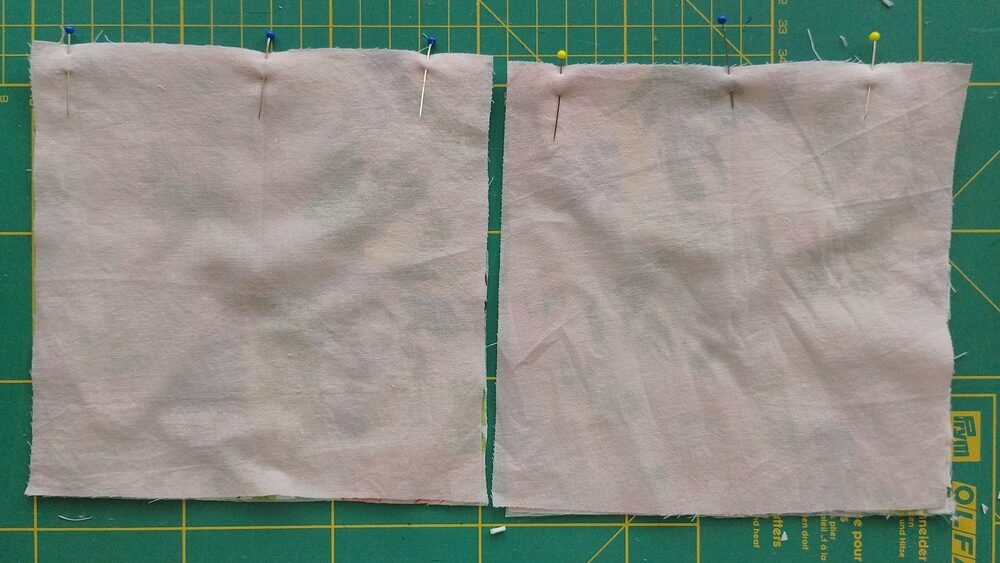 Lining fabric pieces pinned to the main fabric squares.