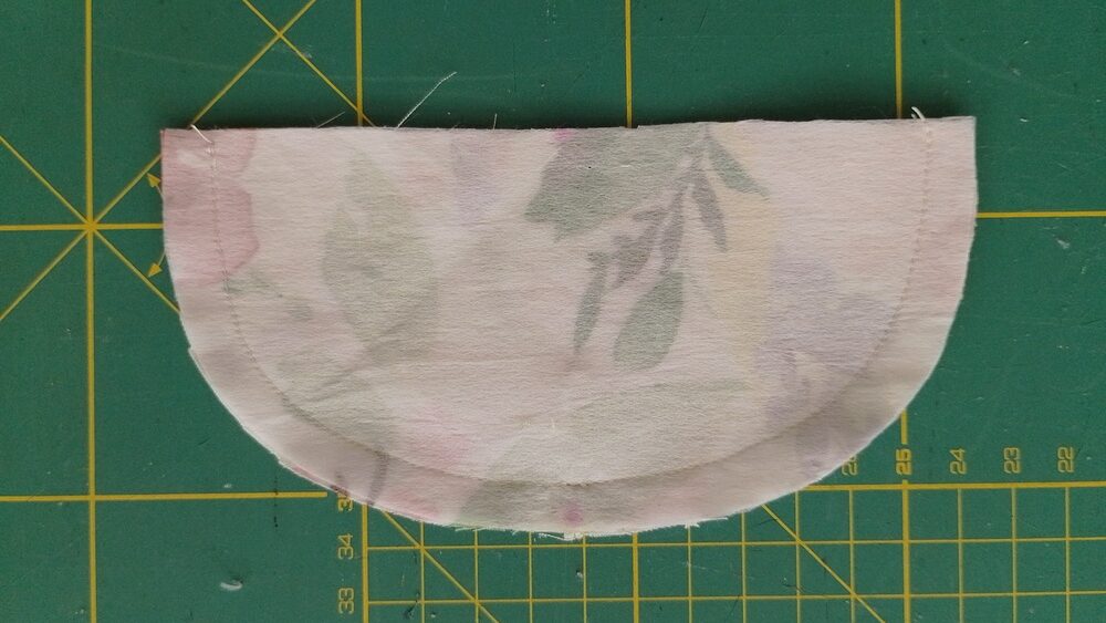 Flap pieces sewn together along the curved edge, wrong sides out, with stitching visible.