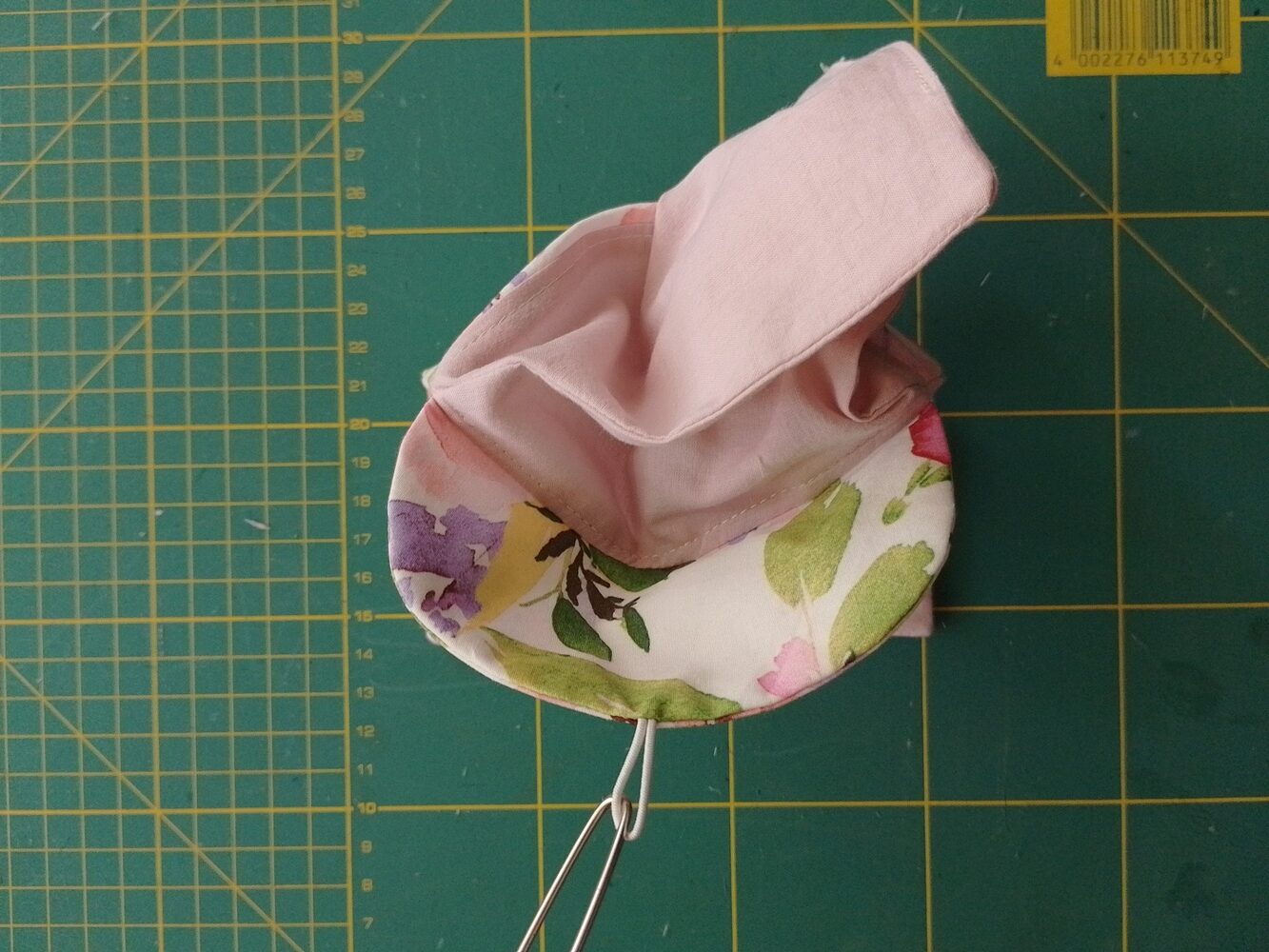 Pink pouch lining being pushed into the main bag with an open flap
