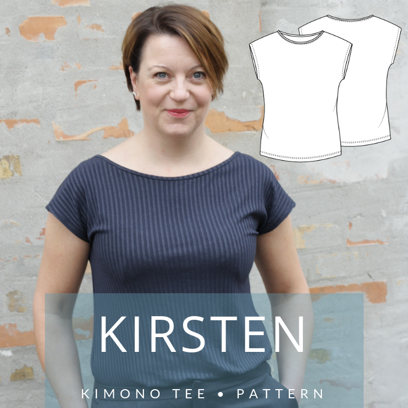 A woman with short brown hair models a dark, vertically striped t-shirt with a wide neckline and dolman cap sleeves against a brick wall. A text overlay reads "KIRSTEN" and "KIMONO TEE • PATTERN", with a technical sketch of the shirt in the top right corner.