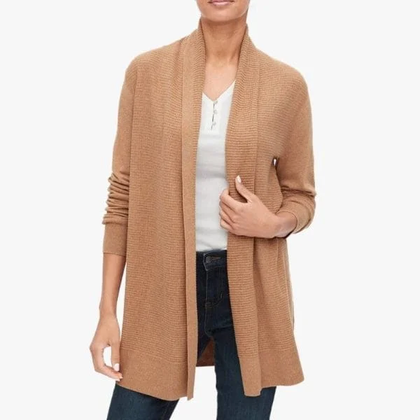 A woman wearing a long, open-front cardigan in a camel color, made from a ribbed knit fabric.