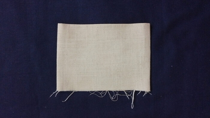 finished stocking cuff made from off-white linen, folded in half to form a clean, double-layered band.