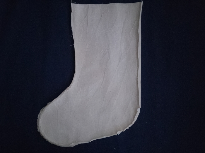 An off-white calico stocking lining with its seam allowances pressed open