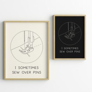 Two framed prints with a line drawing of a sewing machine presser foot and the text 'I sometimes sew over pins', shown in light and dark color versions.