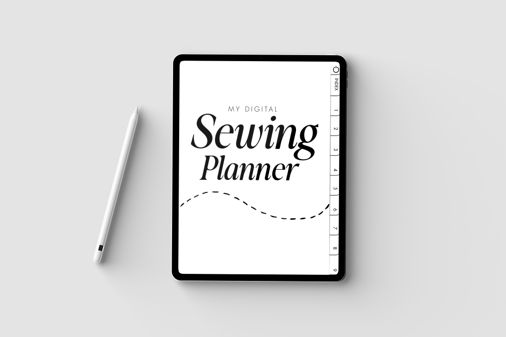 A top-down view of a tablet displaying the cover of the "My Digital Sewing Planner," with a white stylus pen lying next to it on a clean grey surface.