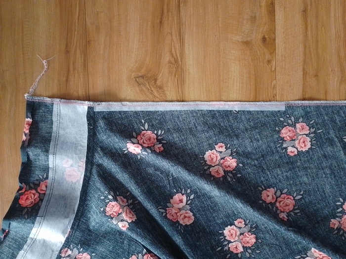 A close-up of the vertical side seam of the skirt, showing the raw edge finished with serging.
