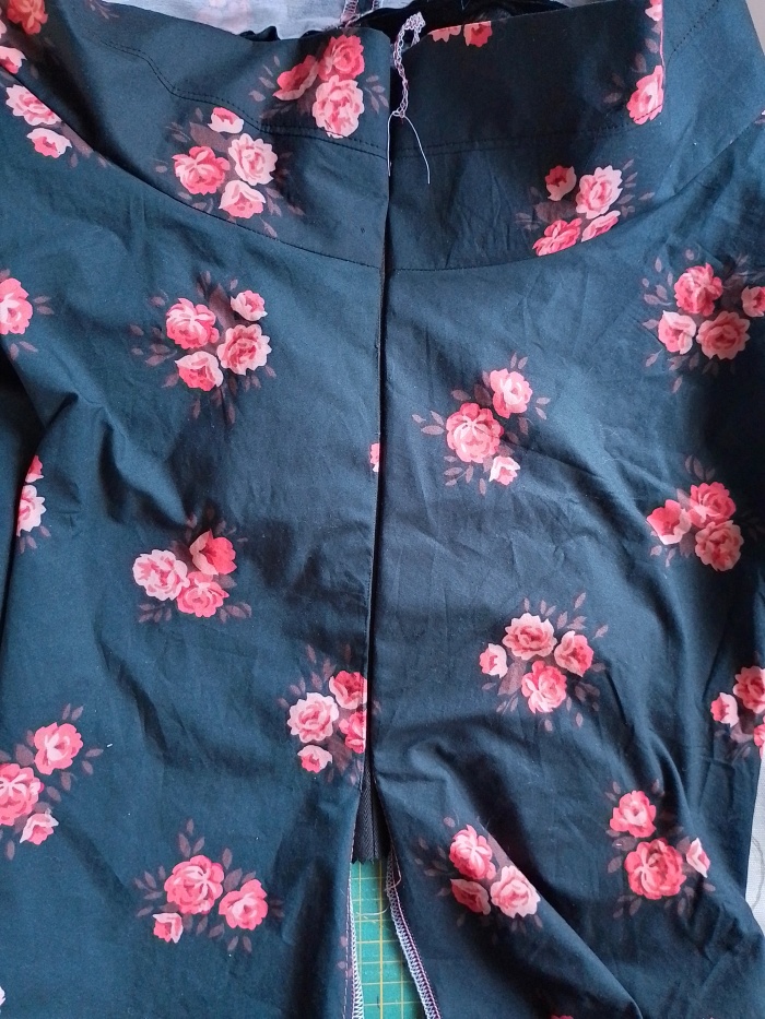 The top of the skirt with the invisible zipper zipped closed, showing the horizontal waistband seam perfectly aligned across the zipper.
