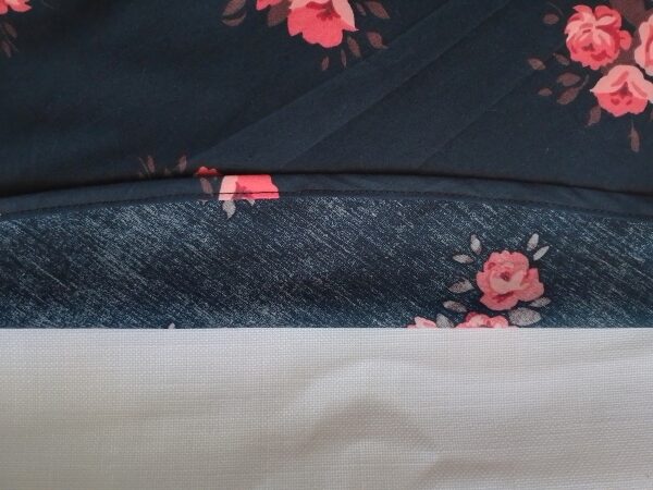 The completed hem of a floral skirt flipped over