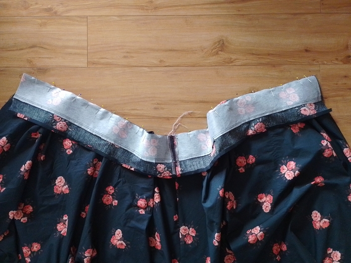 The inner waistband piece pinned to the top waist edge of the skirt.
