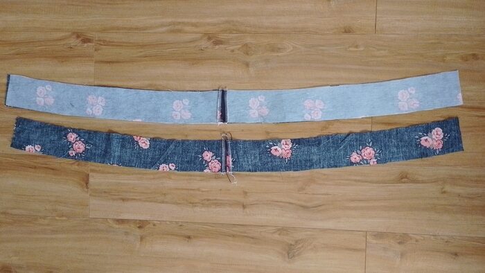 Two long waistband pieces laid out, each formed by joining shorter pieces together with a vertical seam that has been pressed open.