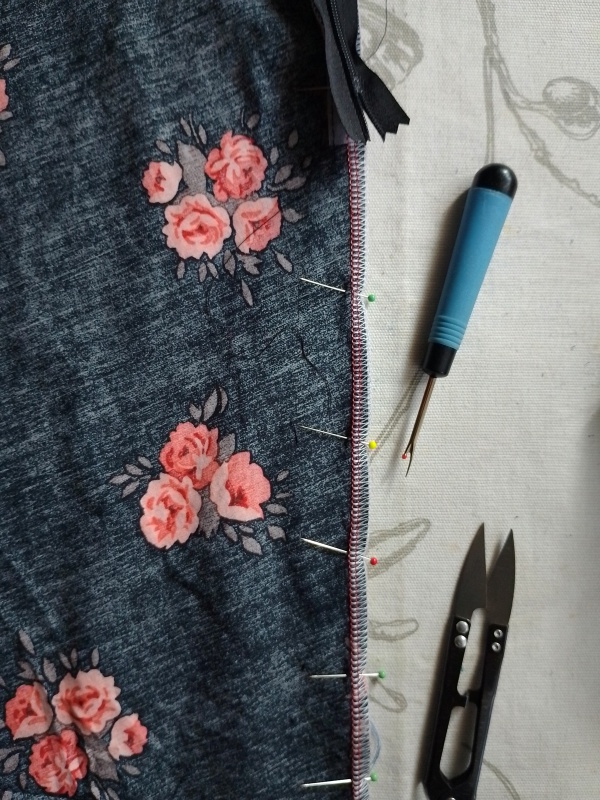 The skirt pieces pinned together below the zipper stop