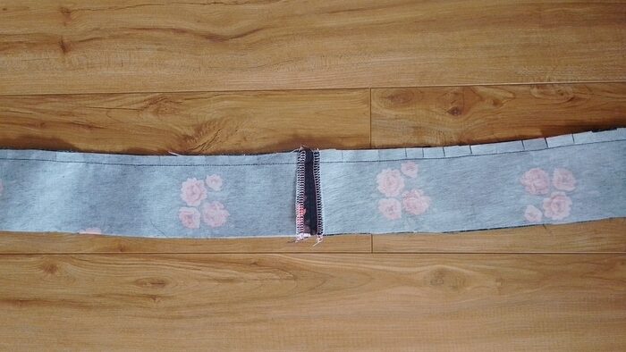 A close-up of the curved waistband seam showing small snips cut into the seam allowance.