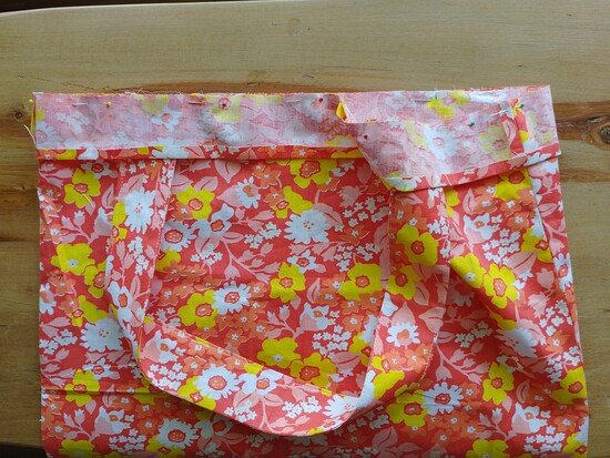 the casing of a tote bag pinned to the top of the tote bag