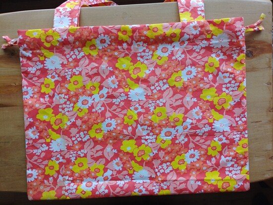 Finished bright floral tote bag on top of a wooden surface