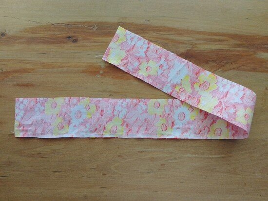 A long floral fabric strip folded lengthwise and sewn along one side.