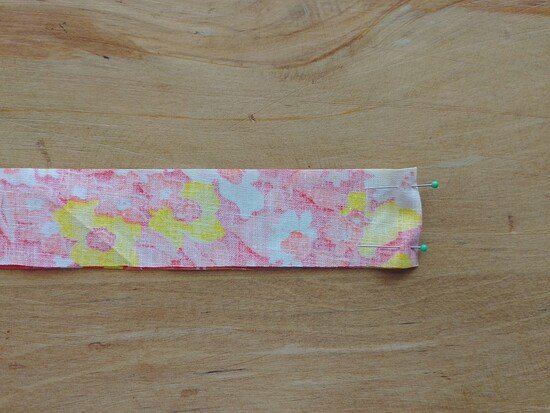 Two pieces of floral fabric pined at the short edge