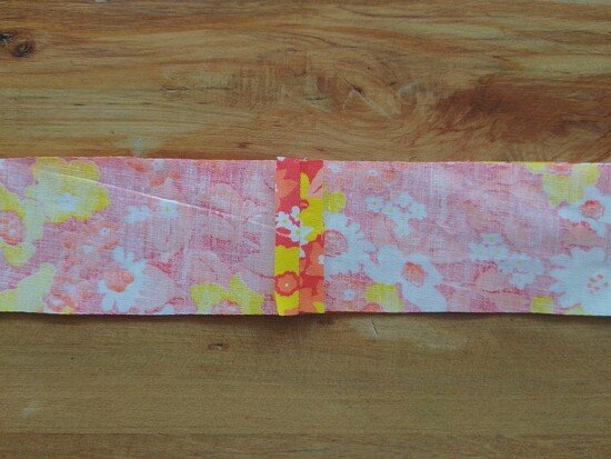 A long strip of floral fabric with the seam pressed open in the center.