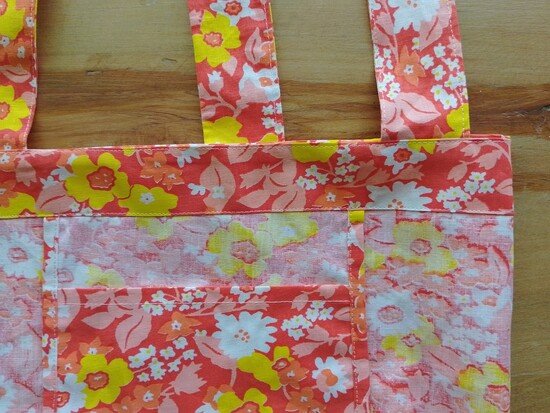 The inside of a tote bag with an attached pocket