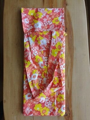 Tote bag folded in thirds with straps laying on top