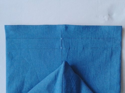 blue chambray bag with two horizontal black lines drawn across it