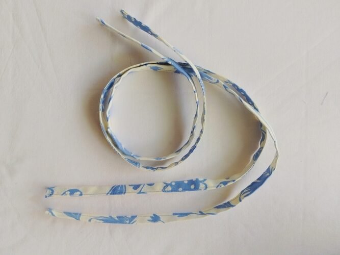 two drawstrings made of blue and off white fabric