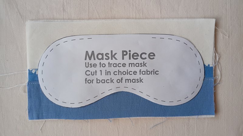 Paper mask pattern piece laid on top of the sunrise patchwork rectangle.