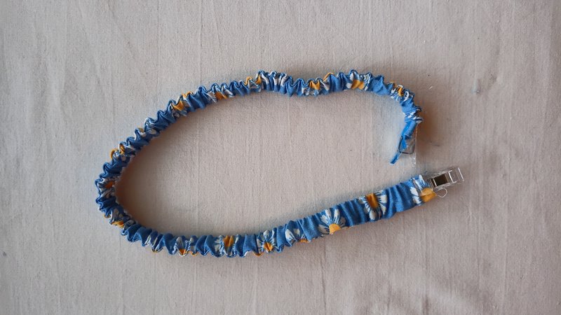 Elastic fabric covered strap clipped at the ends.