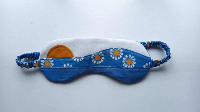 A finished patchwork sleep mask in white yellow and blue fabric