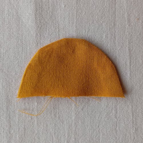 Semi circle of yellow fabric on a white background