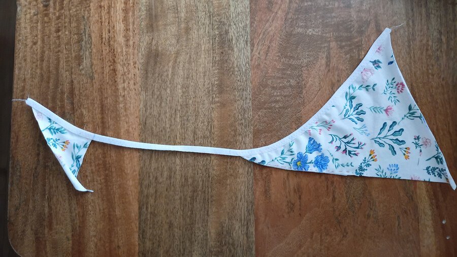One side of the G-string with fold-over elastic sewn in place