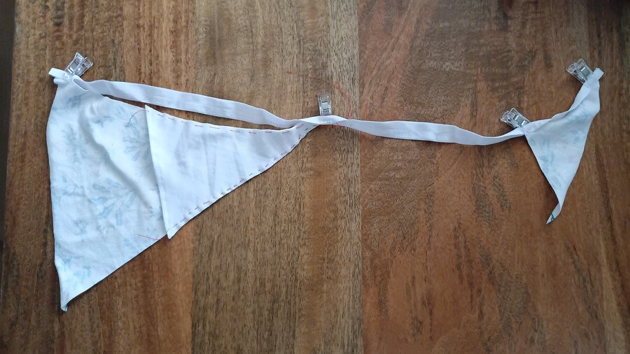 Front and back fabric pieces clipped into fold-over elastic before sewing.
