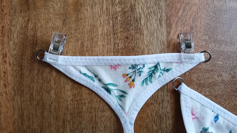 Rings clipped to the back piece of a g-string