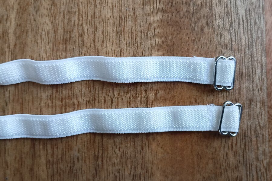 Two strap elastics with sliders secured and the strap sewn