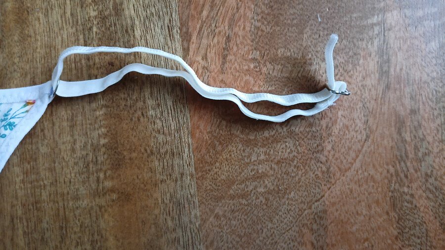 elastic strap threaded into ring on front piece of g-string pattern and into a slider