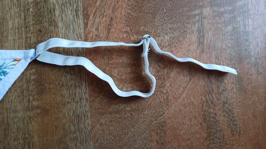 A g-string with an adjustable strap with a free end