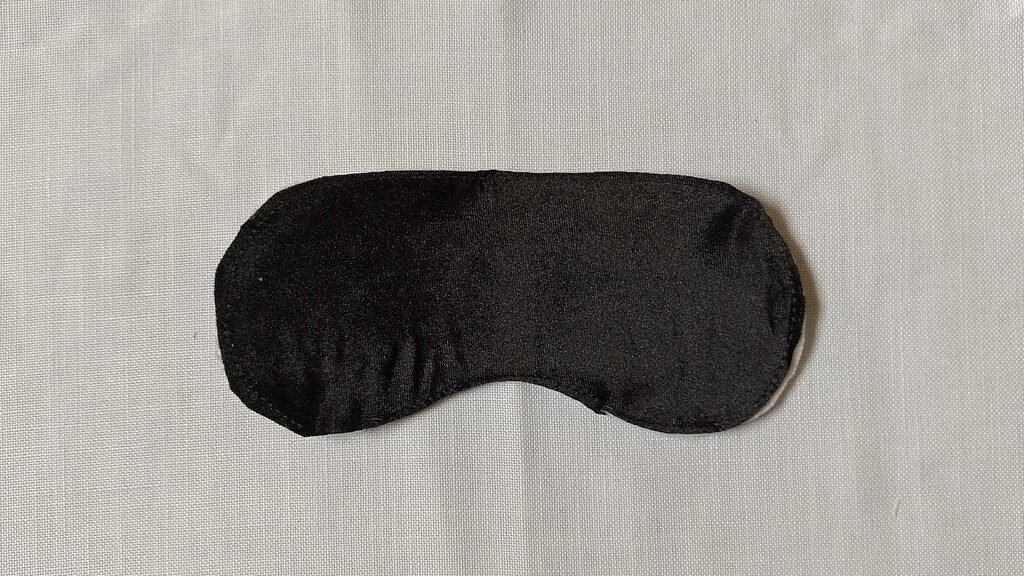 This is an image of the black velvet mask front basted onto the batting