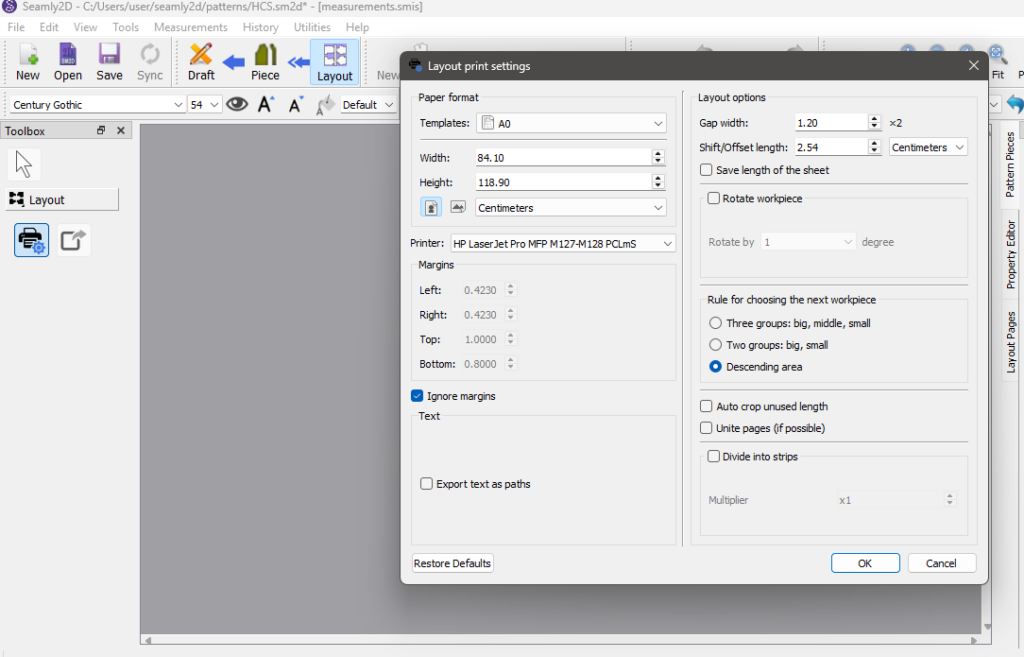 Seamly2D "Layout print settings" dialog with paper template A0 (84.10 by 118.90 cm), margins ignored, and "Descending area" selected as the rule for choosing the next workpiece.