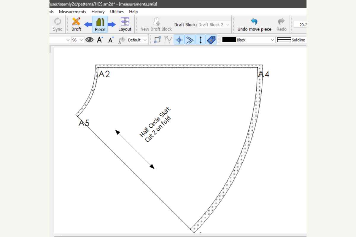 Seamly2D canvas in Piece mode showing the half circle skirt piece with points A2, A4, and A5, a dotted seam allowance, a grainline arrow, and a label reading "Half Circle Skirt, Cut 2 on fold."