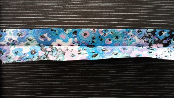 Floral fabric strip folded in half lengthwise to make a center crease