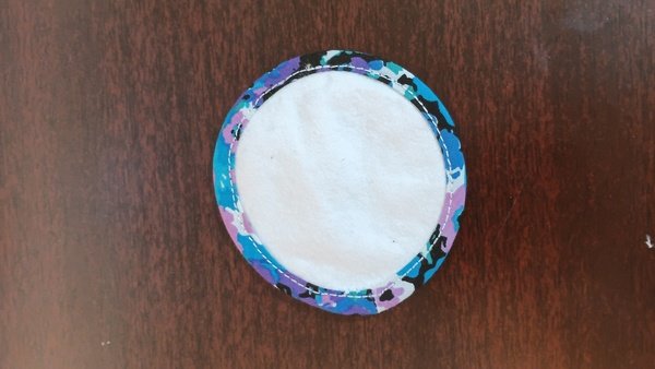 Finished flannel reusable cotton round with floral bias tape edge stitched all the way around