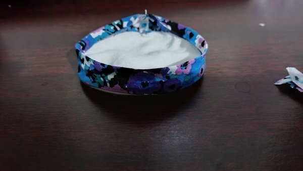 Flannel round with floral bias tape sewn on and the loose tape end sticking out