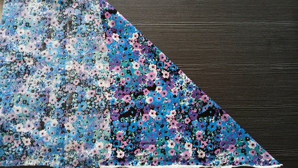 Blue and purple floral fabric folded diagonally on the bias