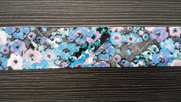 Two floral fabric strips joined at a right angle with a diagonal seam