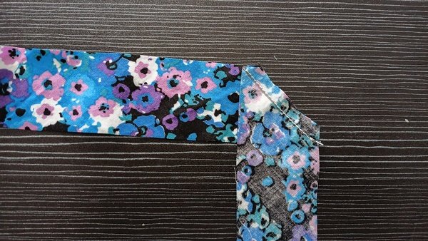 Flannel round with floral bias tape ends overlapped and trimmed scraps beside it